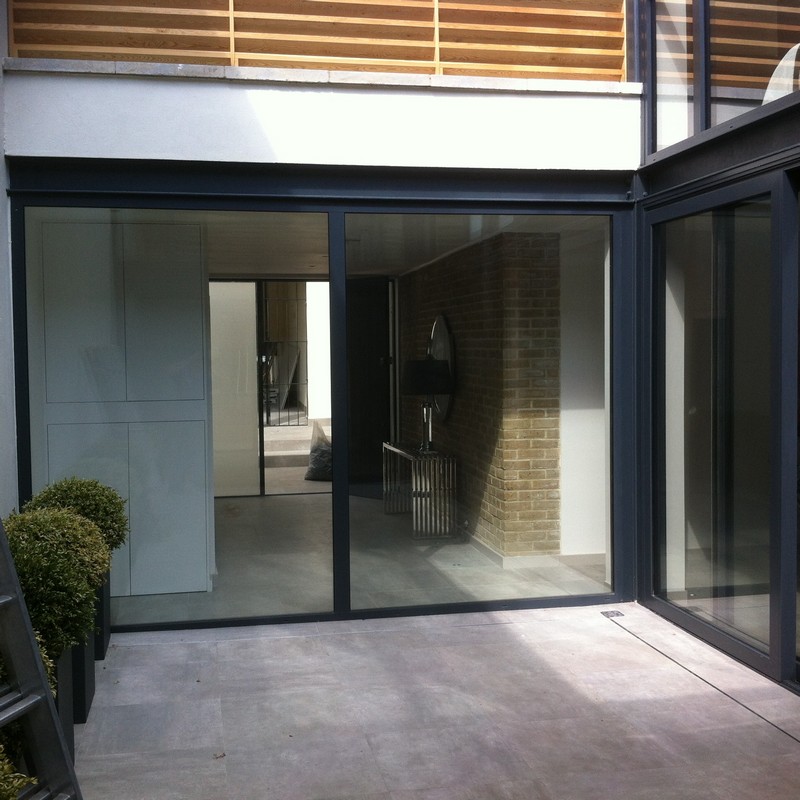 Floor-to-ceiling sliding doors opening to courtyard in Forest Gate