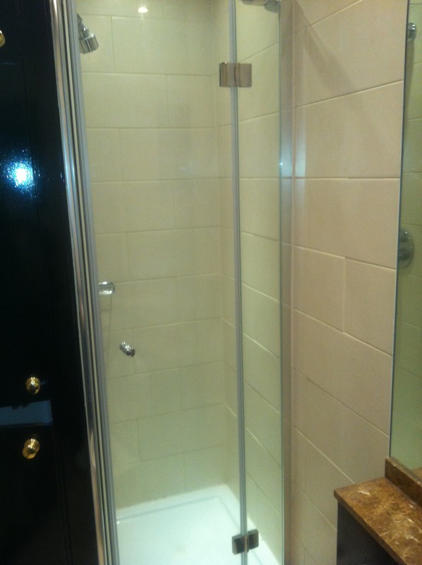Frameless glass shower enclosure with chrome fittings in Forest Gate